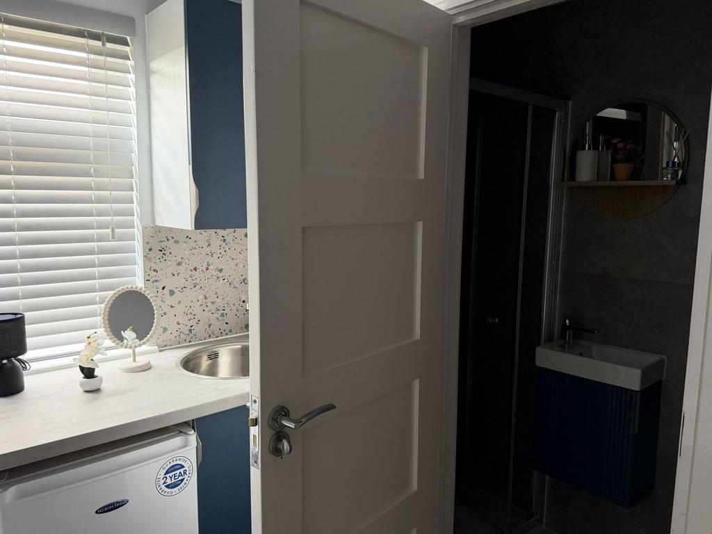 Modern bathroom with stylish fixtures and tilin...