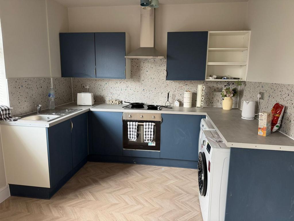 Stylish blue kitchen with terrazzo splashback...