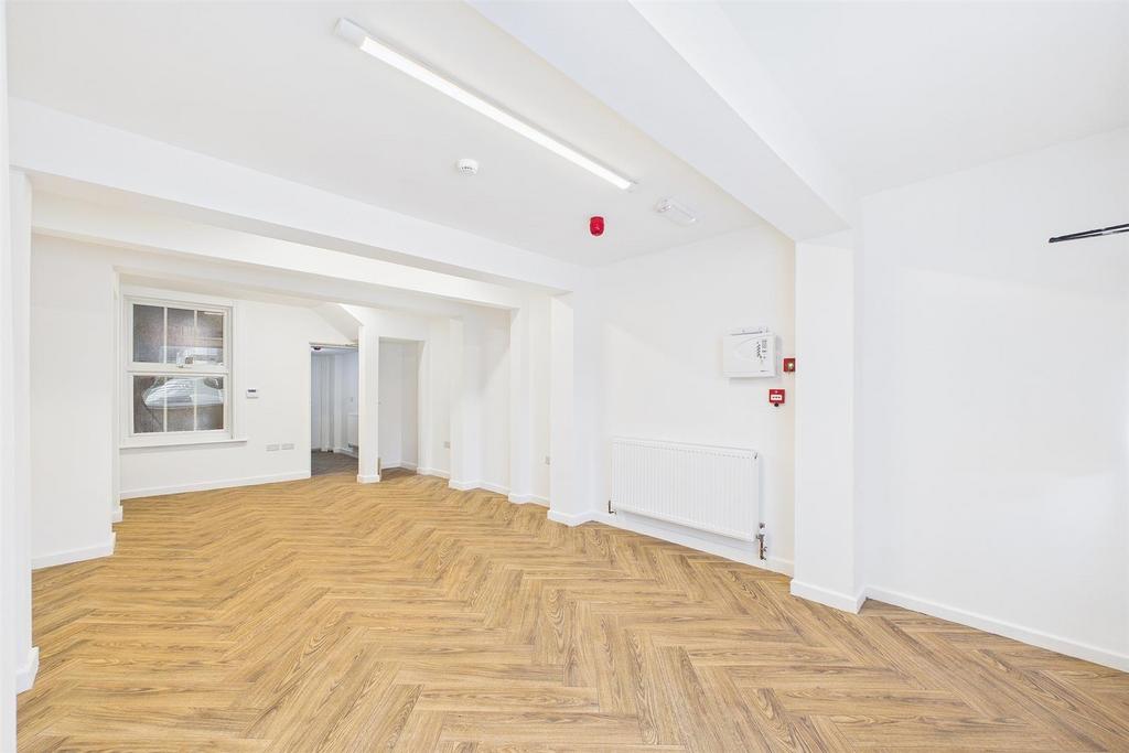 Bright lounge with elegant herringbone flooring...