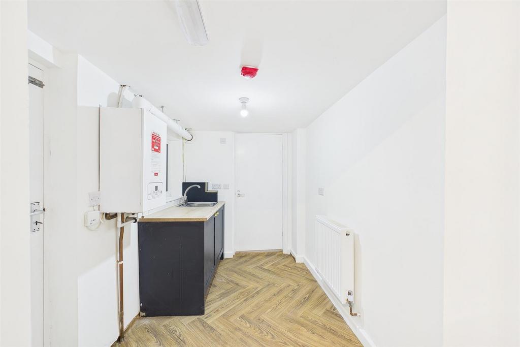 Modern utility space with stylish wood flooring...