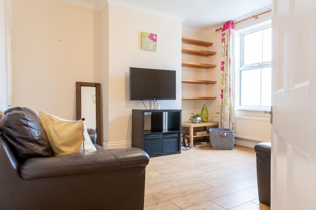 Bright, well-kept living room with a wall-mount...