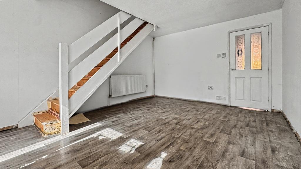 Bright living area with modern wood-style floor...