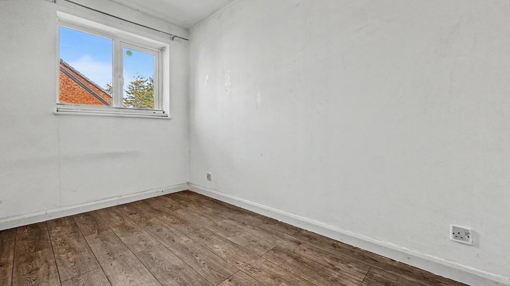 Bright bedroom with stylish wooden flooring...