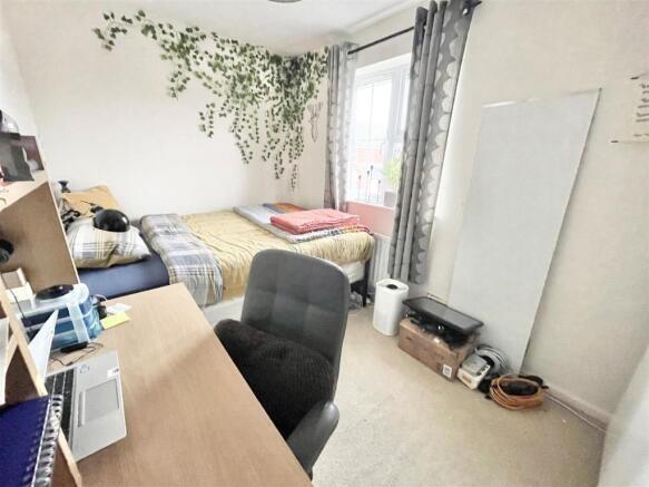 Bright, neatly arranged bedroom with a window, ...