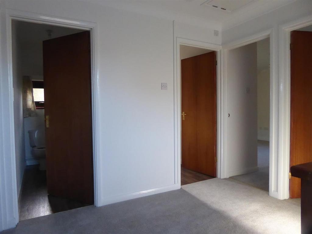 Bright and tidy landing with plush carpeting...