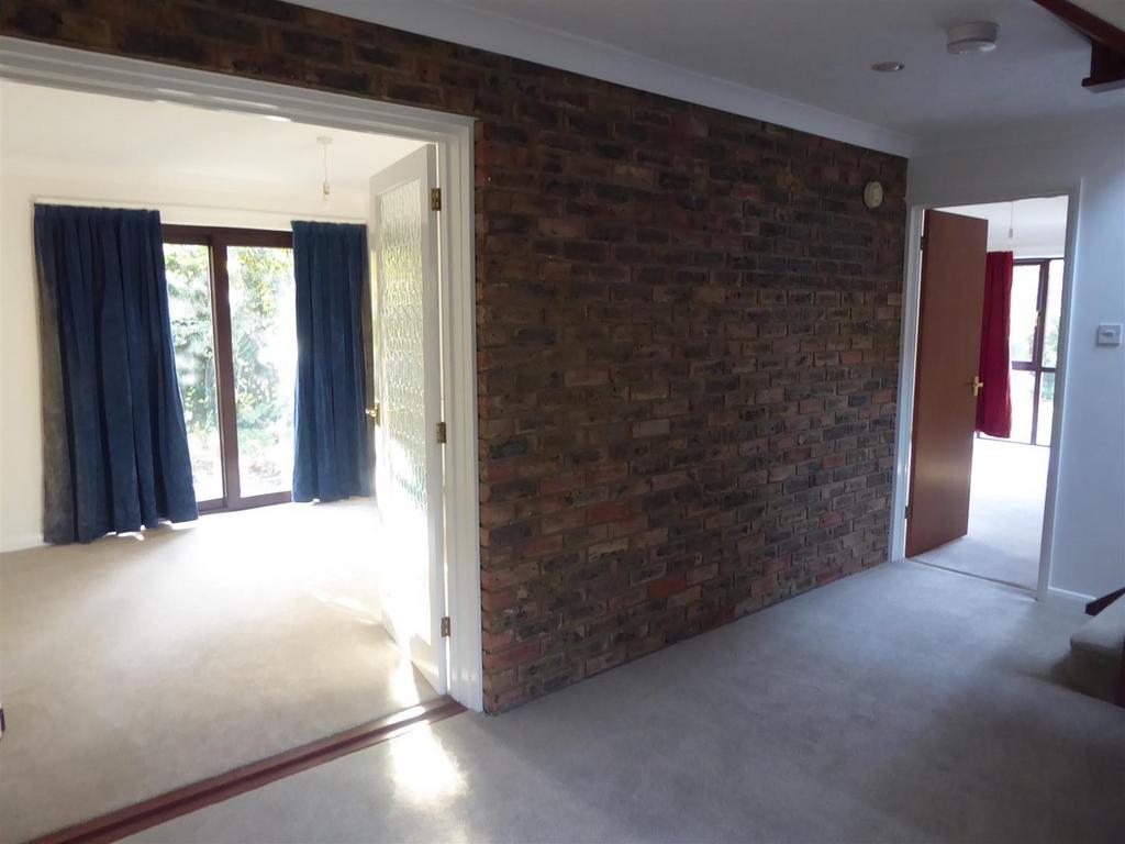 Bright hallway with stylish exposed brick wall...