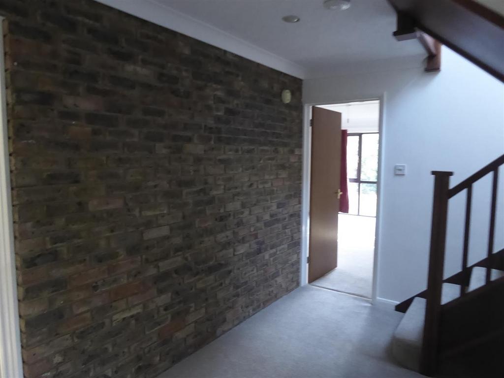 Modern hallway with a stylish brick feature wal...
