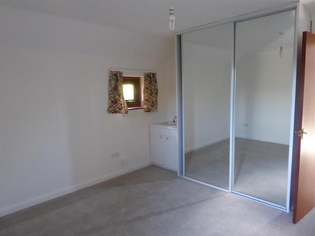 Bright bedroom with large mirrored wardrobes...