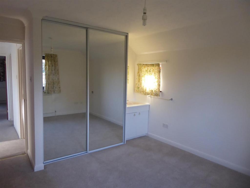 Bright bedroom with large mirrored wardrobes...