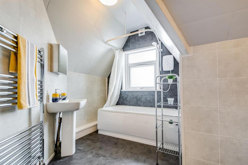 Bright, modern bathroom with a full-size bath b...