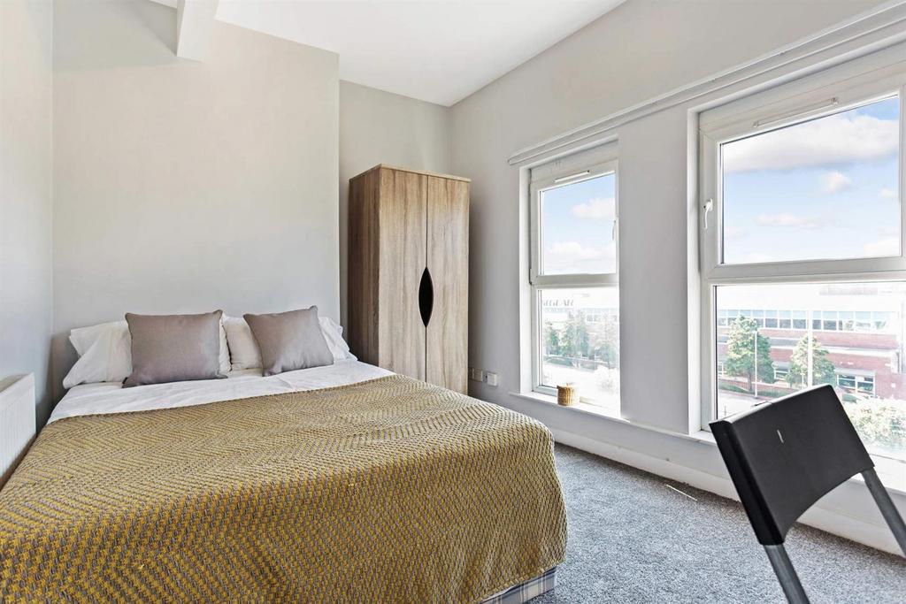 Bright, modern bedroom with a comfortable doubl...