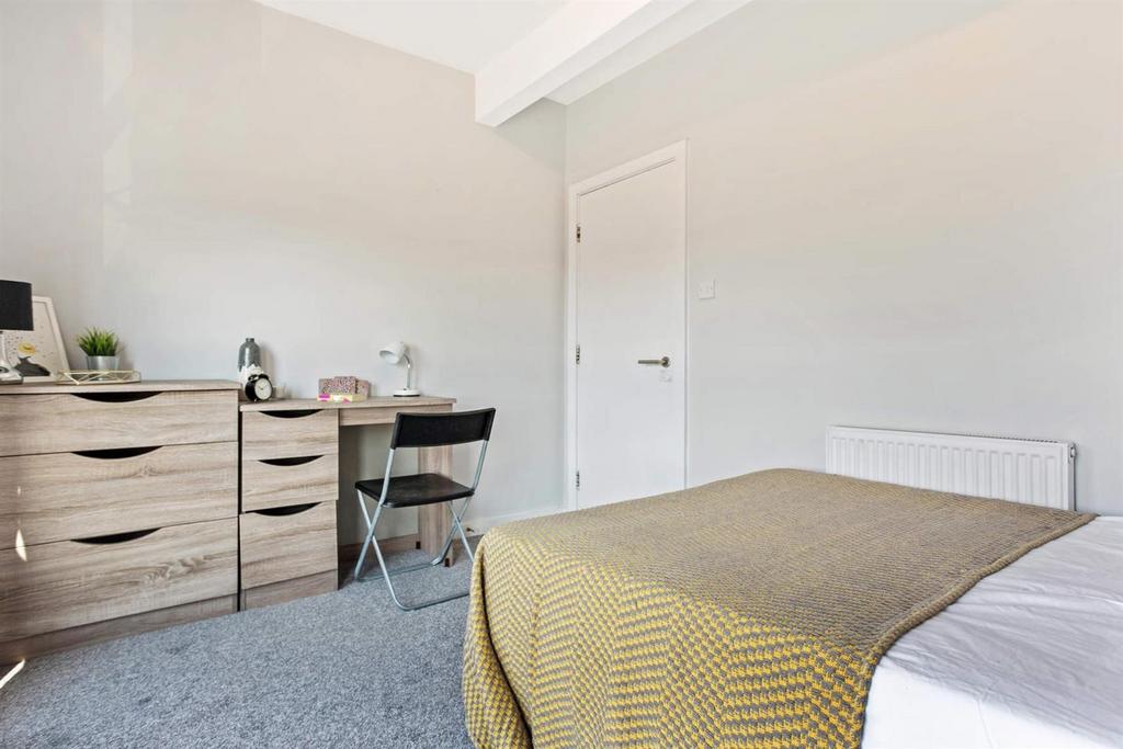 Bright, neatly presented bedroom with a comfort...
