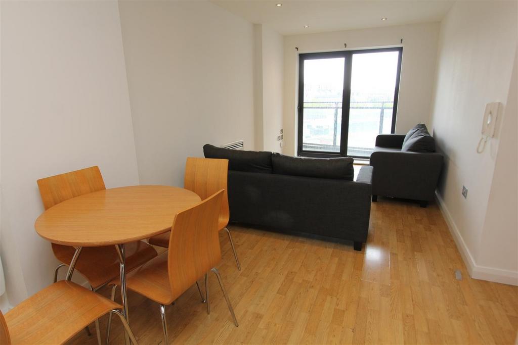 Bright lounge with a dining area and balcony....