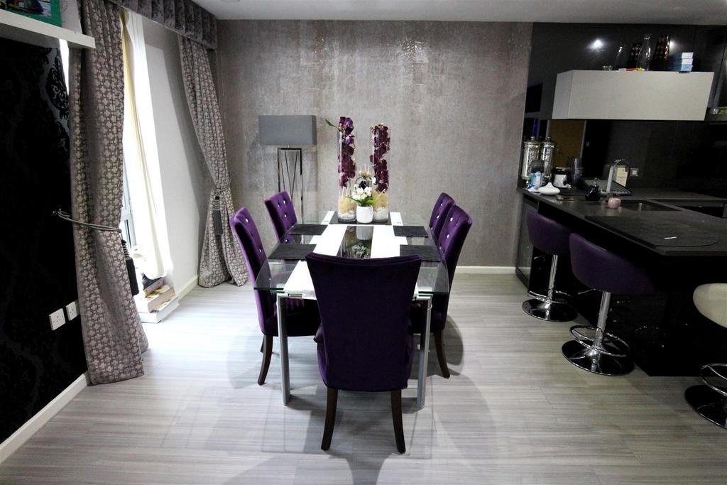 Contemporary dining area with purple-accented s...