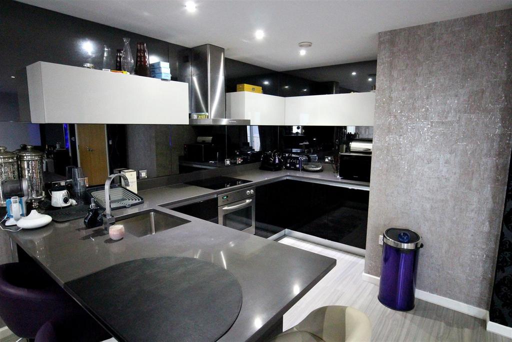 Modern sleek fitted kitchen with glossy units...