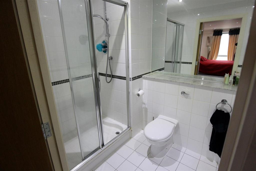 Bright modern bathroom with shower and crisp ti...