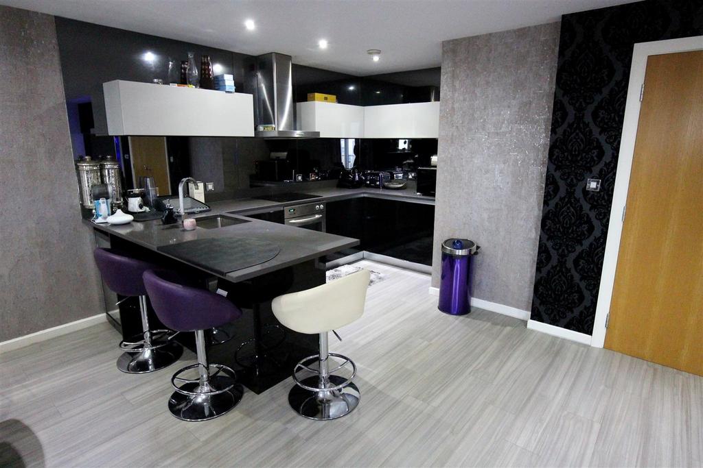 Stylish modern kitchen with breakfast bar seati...