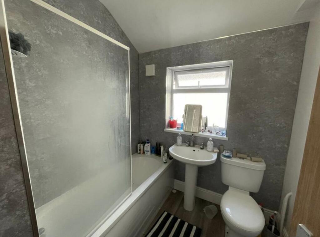 Modern bathroom with bathtub and shower screen,...