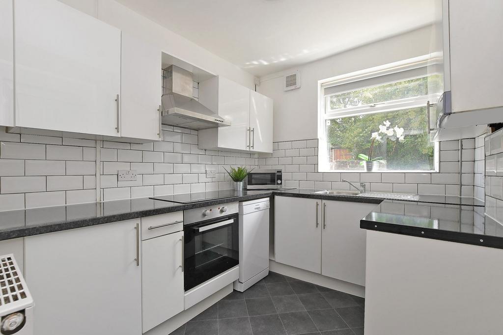 Bright, modern kitchen with glossy white cabine...