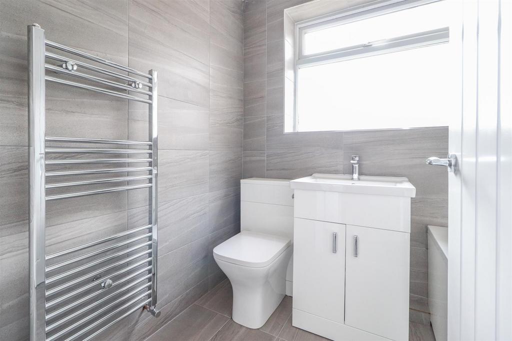 Modern bathroom with sleek tiles and towel rail...