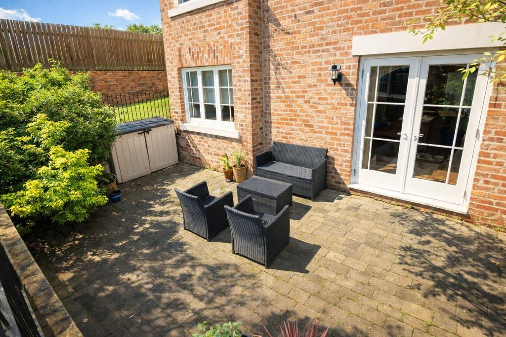 Sunny patio with black wicker furniture