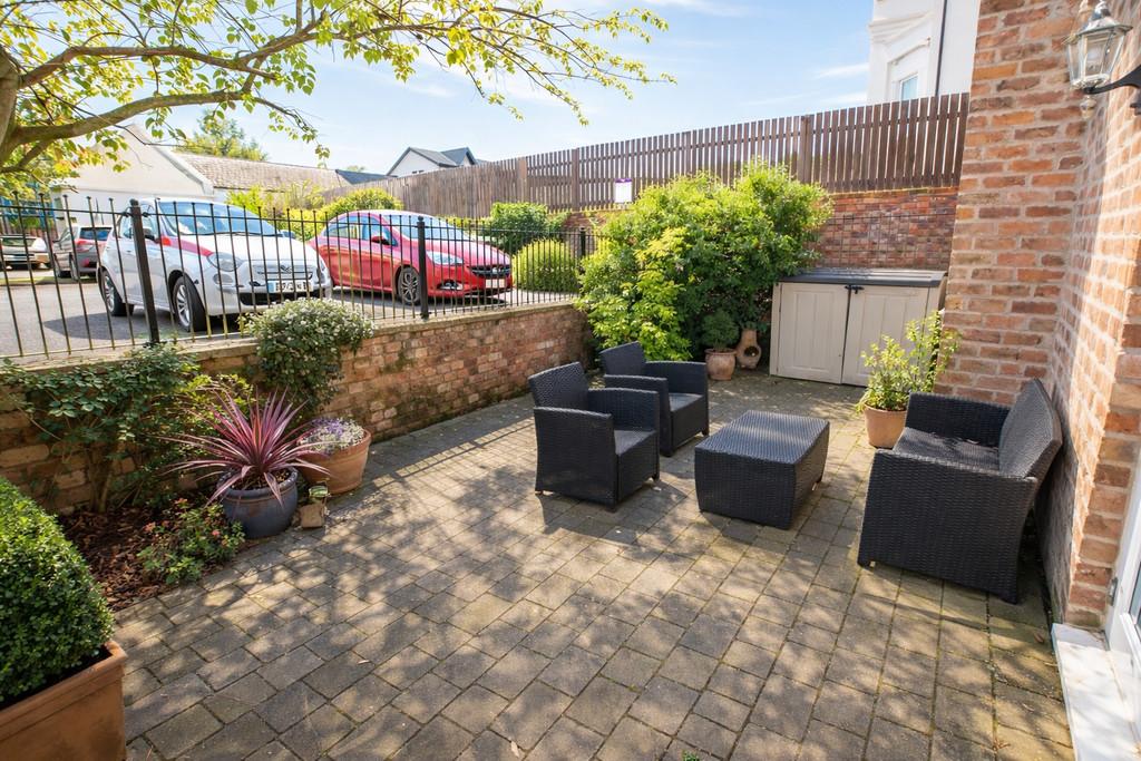 Sunny garden patio with wicker furniture