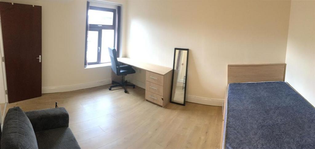 Bright, spacious bedroom with desk and sofa...