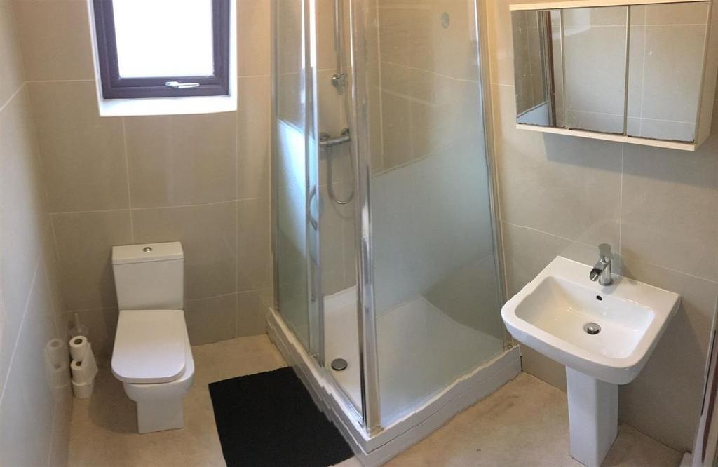 Bright modern shower room with sleek tiling...