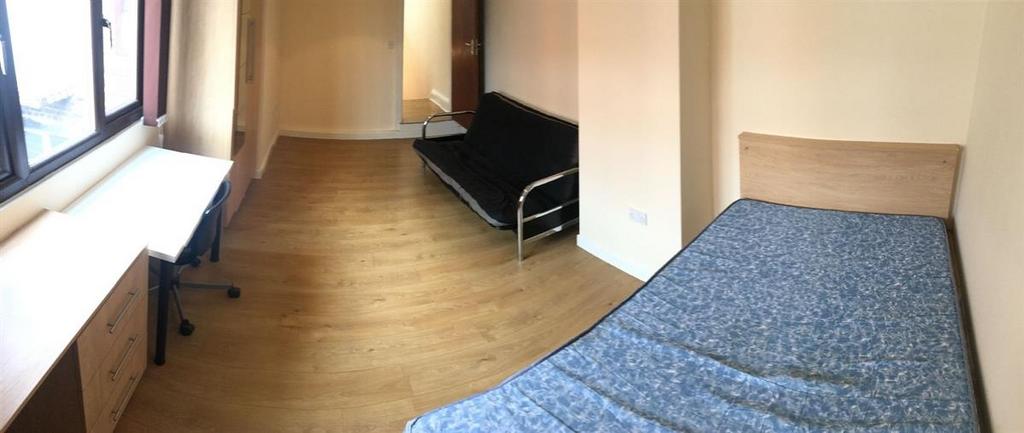 Spacious room with study desk and sofa...