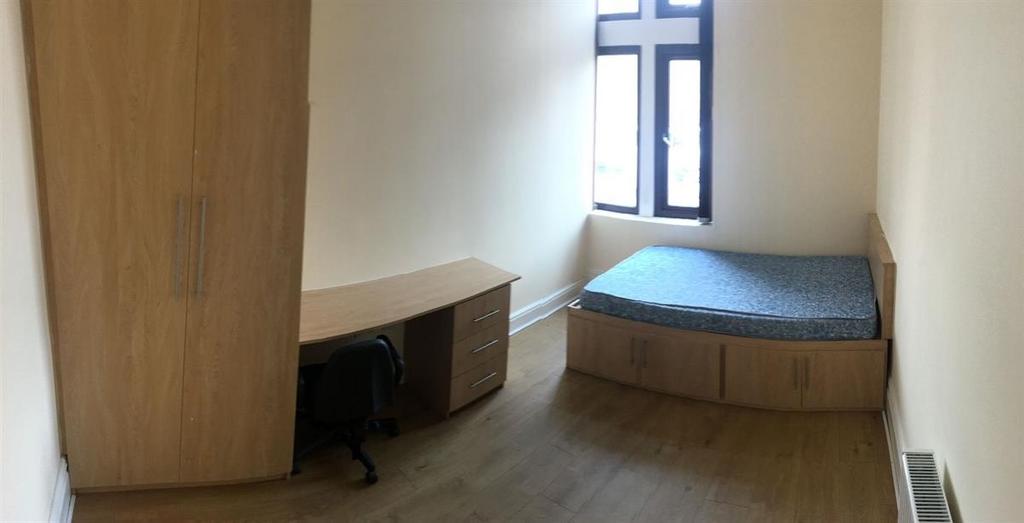 Bright bedroom with integrated storage and desk...