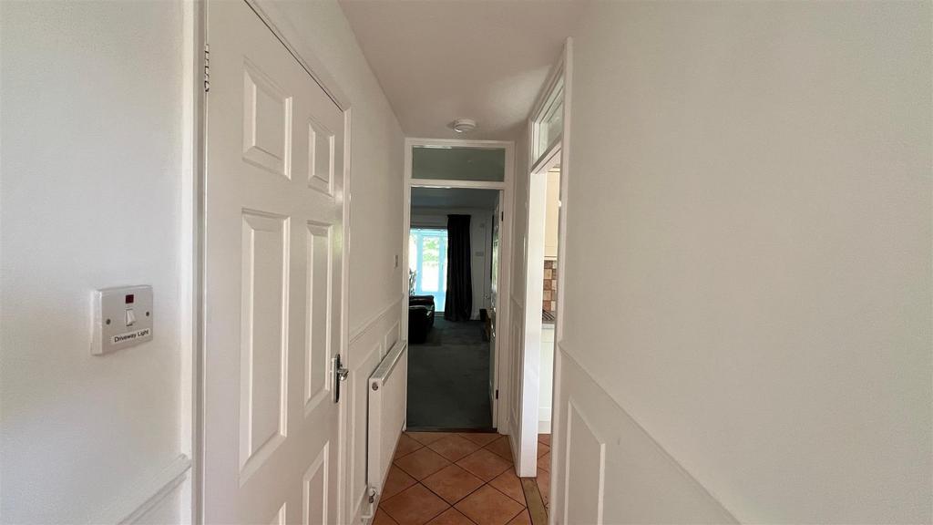 Bright simple hallway with tiled floor...