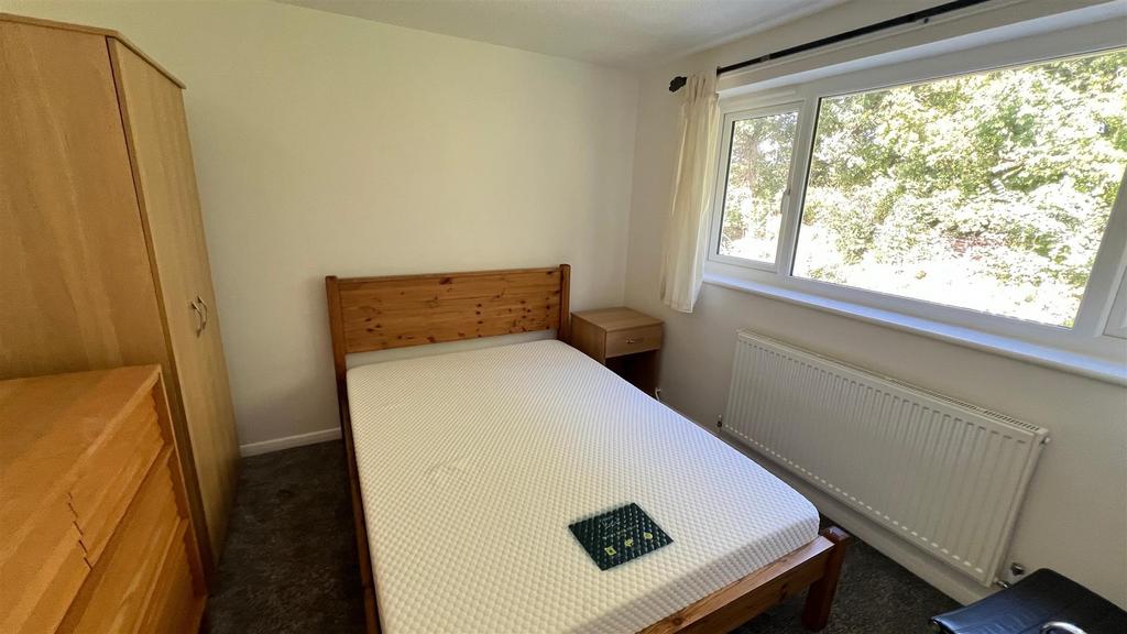 Bright double bedroom with window and wardrobe...