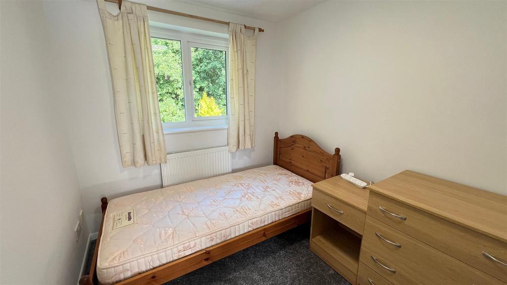 Simple bedroom with bed, window and storage...