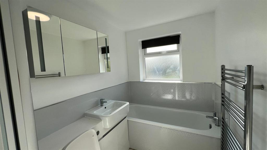 Modern white bathroom with bath and vanity...