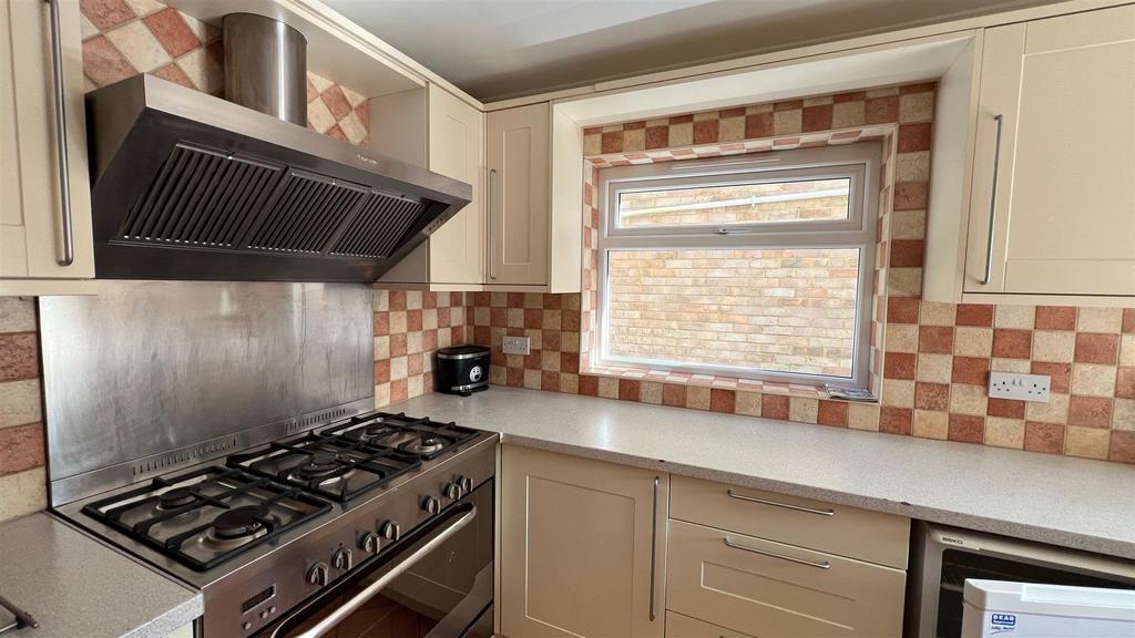 Bright fitted kitchen with gas hob and storage...