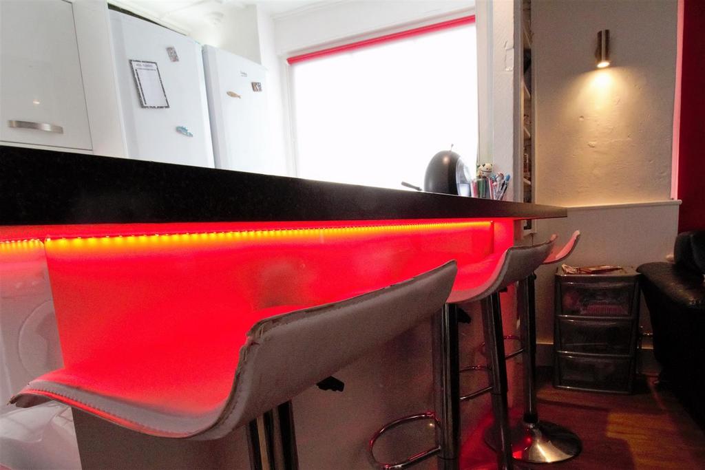 Modern kitchen bar with vibrant LED lighting...