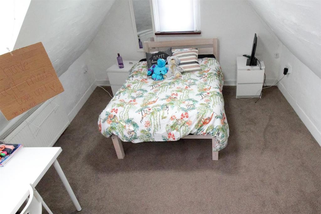 Cozy attic double bedroom with bed and bedside ...