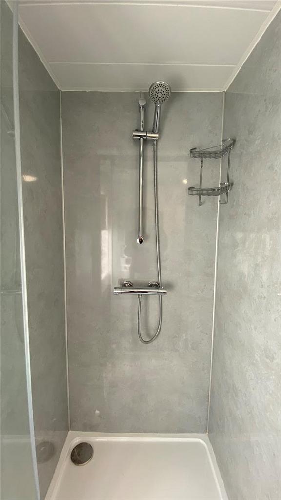 Modern tiled shower with chrome fittings...