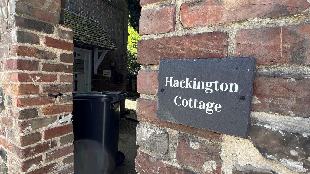 Charming cottage entrance with exposed brick an...