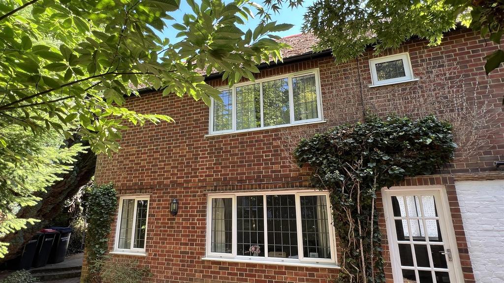 Attractive brick-front house with greenery and ...