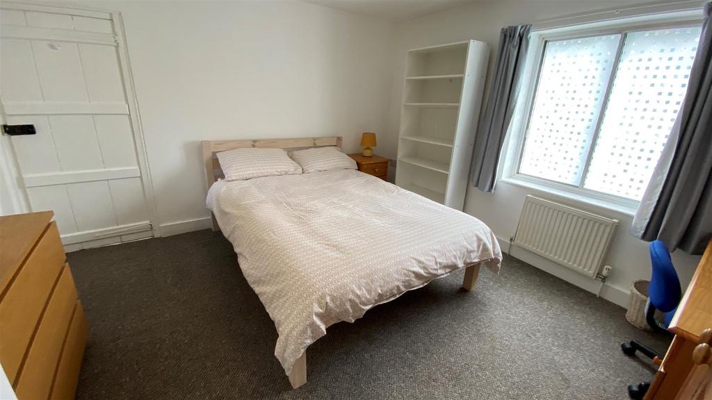 Bright bedroom with double bed and storage...