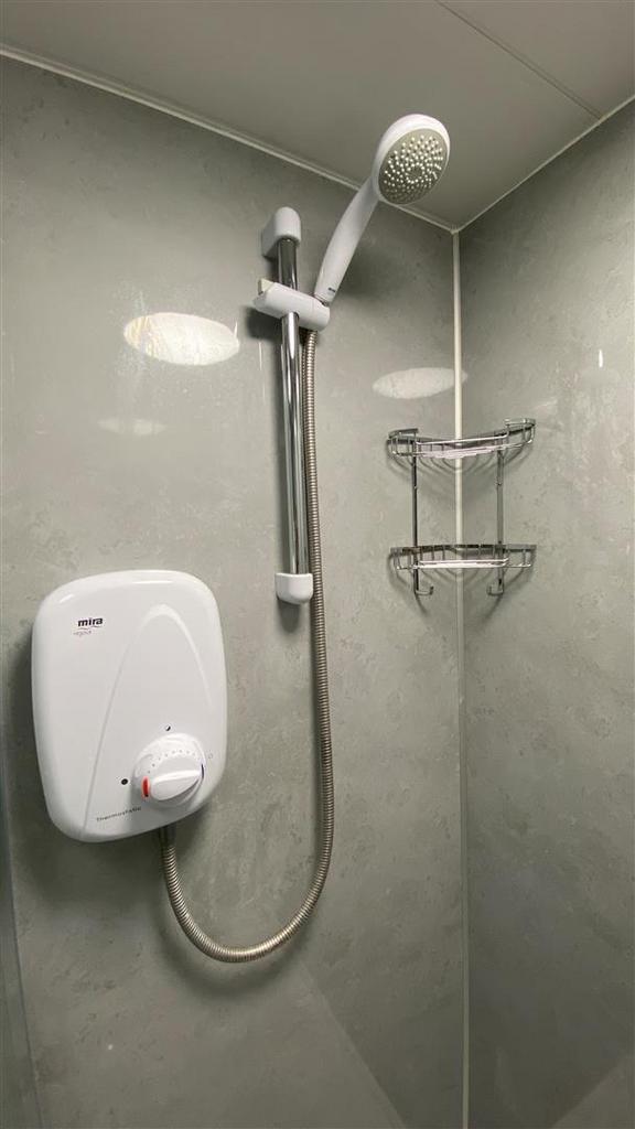 Modern tiled shower with electric unit and cadd...
