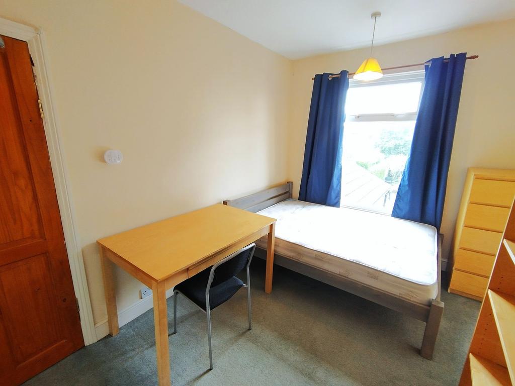 Bright single bedroom with a large window and n...