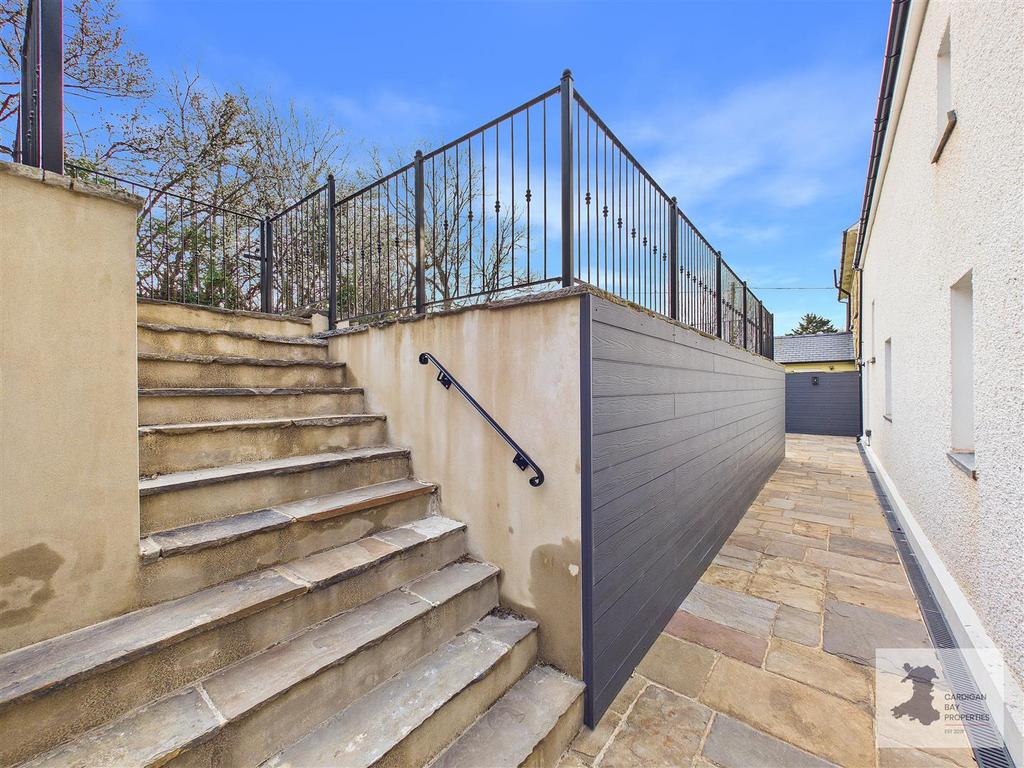 Rear garden/patio and steps to parking
