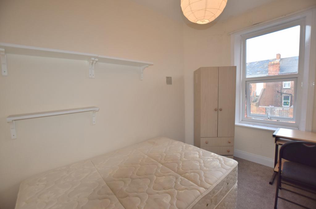 A bright and inviting double bedroom featuring ...