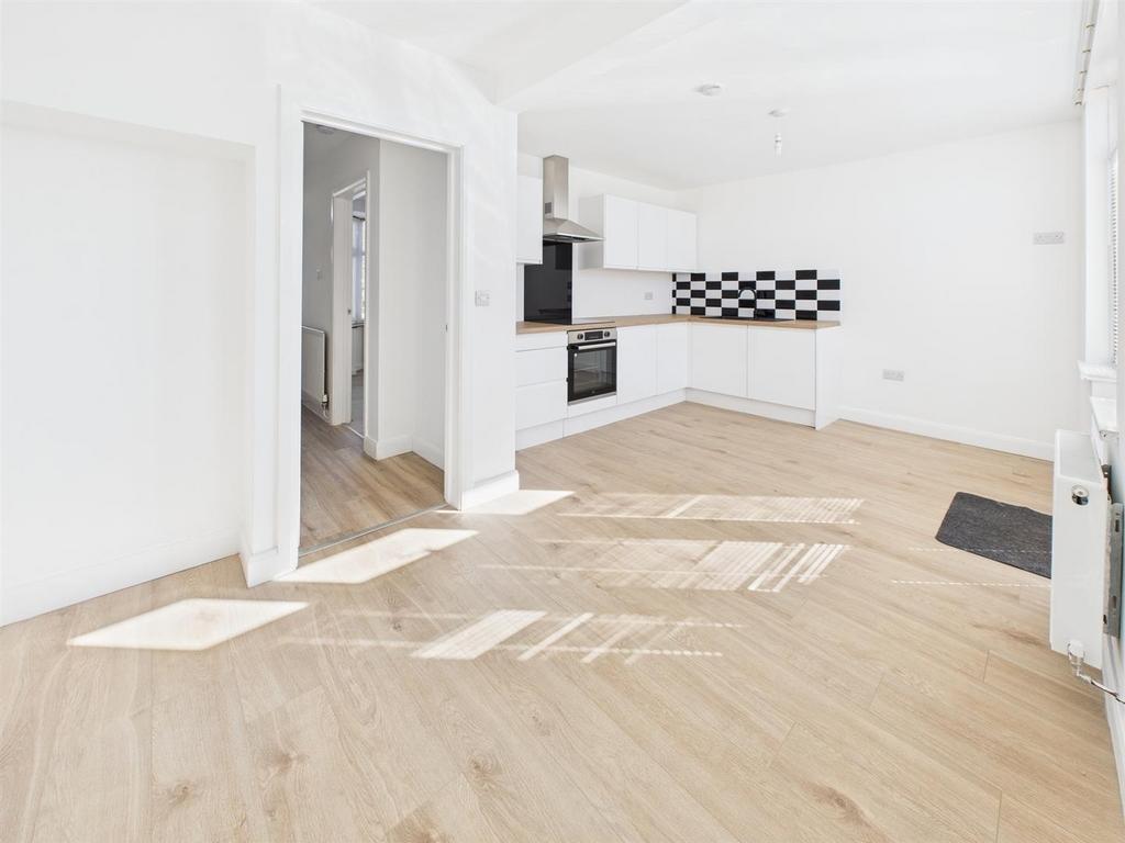 Bright modern kitchen with stylish wood floorin...