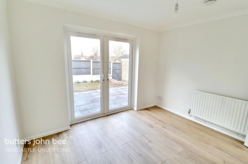 Bright room with patio doors and wood flooring...