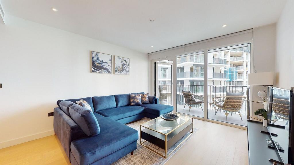 Bright modern lounge with large navy sectional...