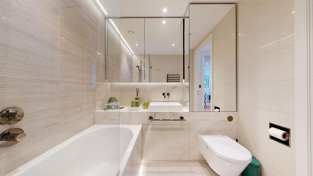 Modern tiled bathroom with bath and vanity...