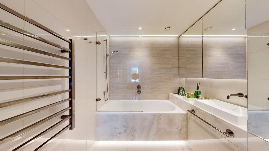 Bright modern bathroom with bathtub and vanity...